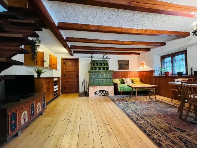 Living room with the original tiled wood-burning stove