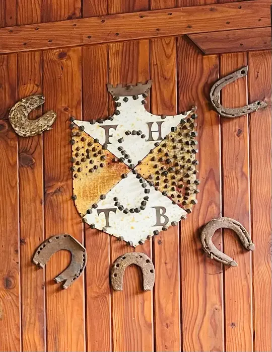 Decorative wall crest and horseshoes, a traditional touch inside the cabin