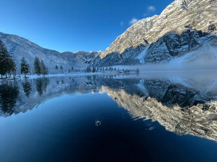 Winter view of Lake Bohinj with the mountains reflected in still water